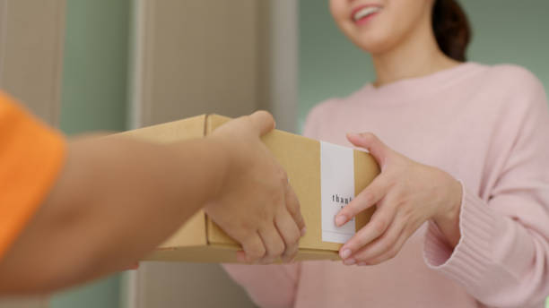 Courier delivering an e-commerce parcel to a customer